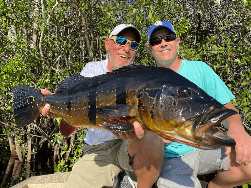 Business professionals enjoying an Amazon fishing expedition and team retreat