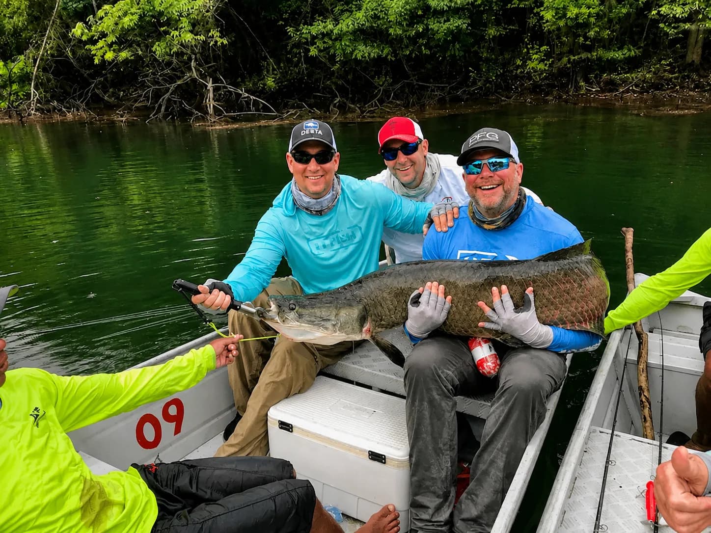 Guests celebrating an Arapaima catch during an Amazon corporate retreat
