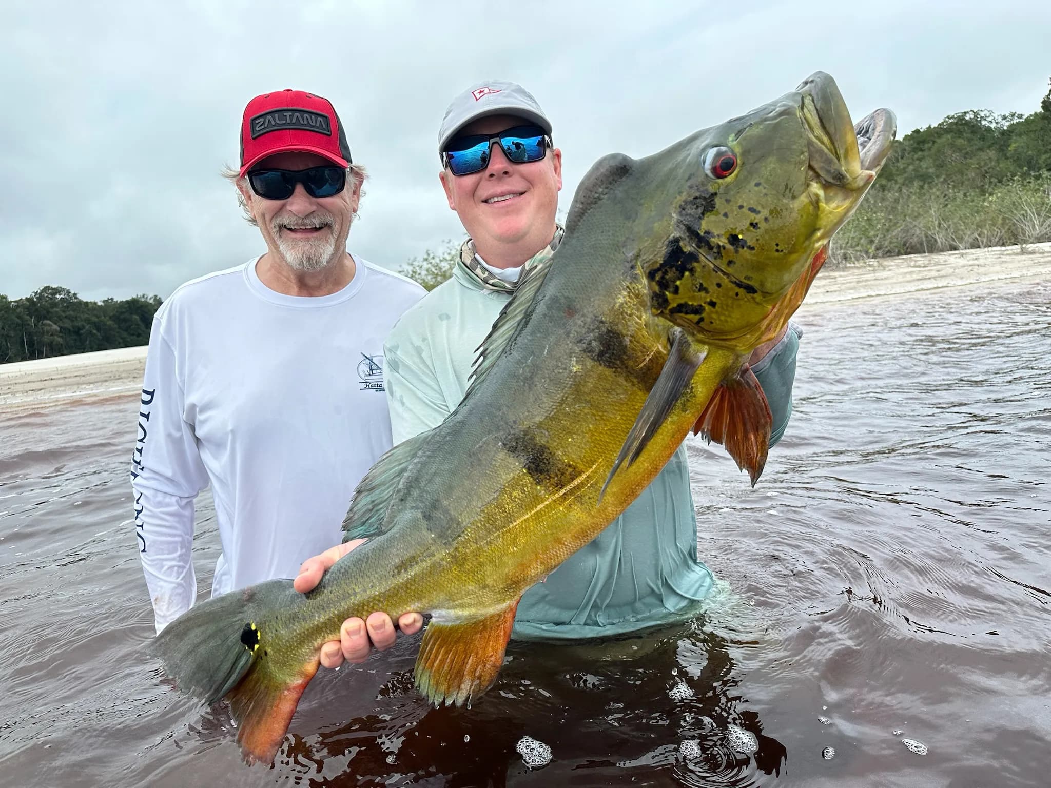 Family members celebrating an Arapaima catch